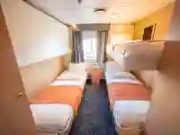 The triple cabin (4) have three single beds, one of which is a bunk bed, wardrobes and a private bathroom with shower and toilet. – Norwegian Adventure Company