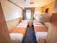 The triple cabin (4) have three single beds, one of which is a bunk bed, wardrobes and a private bathroom with shower and toilet. – Norwegian Adventure Company