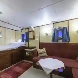 Double cabin superior: Double bed, a small lounge and wardrobe. Washbasin with hot and cold water. – Norwegian Adventure Company