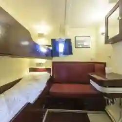 Double cabin: Upper and lower bunk, a small sofa and wardrobe. Washbasin with hot and cold water. – Norwegian Adventure Company