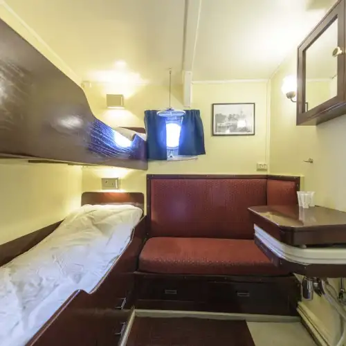Double cabin: Upper and lower bunk, a small sofa and wardrobe. Washbasin with hot and cold water. – Norwegian Adventure Company